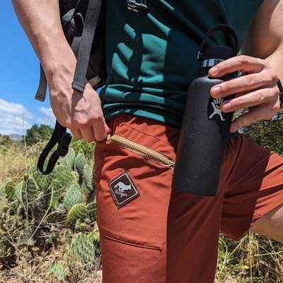 Runyon Mens Red Rock (Rust) TrailStash 7 Inch Gravel Short a performance short with zipper pockets that works great for Hiking