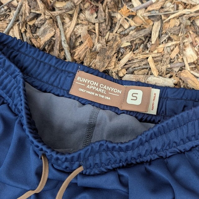 Runyon SupraPlush™ navy blue 5-inch men's running shorts with 2-in-1 compression liner, lightweight performance shell, dual side pockets, phone pockets, handcrafted in Los Angeles, Made in USA.