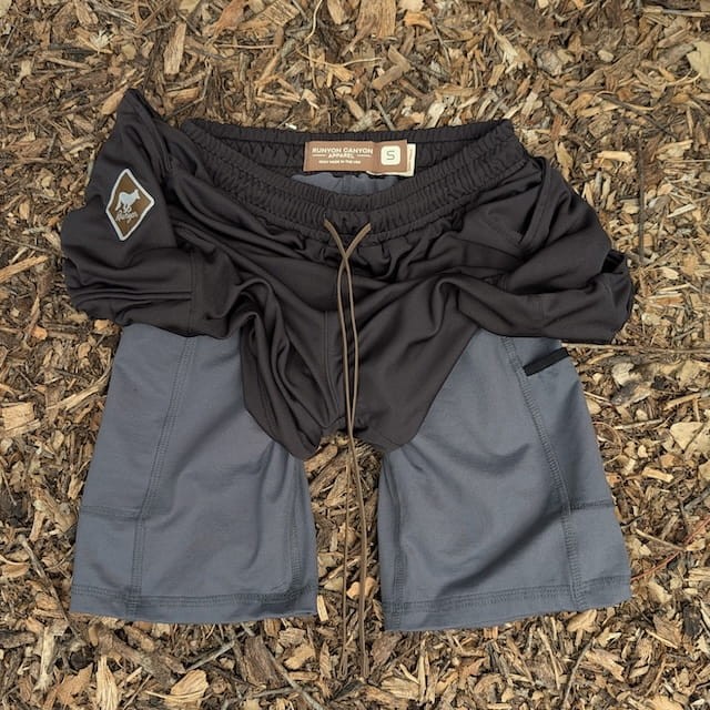 Runyon SupraPlush™ black 5-inch men's running shorts with 2-in-1 compression liner, lightweight performance shell, dual side pockets, phone pockets, handcrafted in Los Angeles, Made in USA.