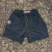Runyon SupraPlush™ black 5-inch men's running shorts with 2-in-1 compression liner, lightweight performance shell, dual side pockets, phone pockets, handcrafted in Los Angeles, Made in USA.