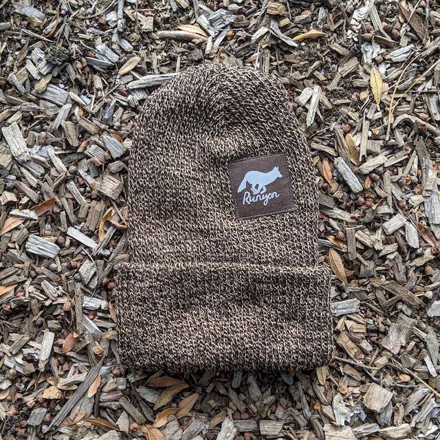 Runyon Wild Cocoa Reflective Performance Knit Beanie 
a brown heather marl beanie compliments our dark brown reflective patch